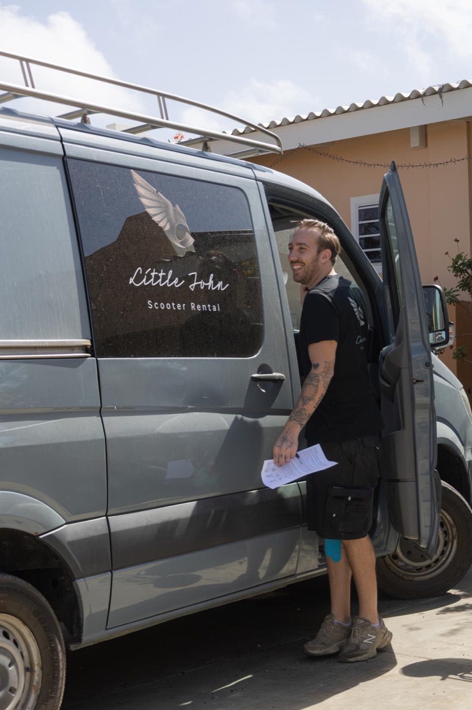 Sjonnie smiling at the door of the Little John delivery van