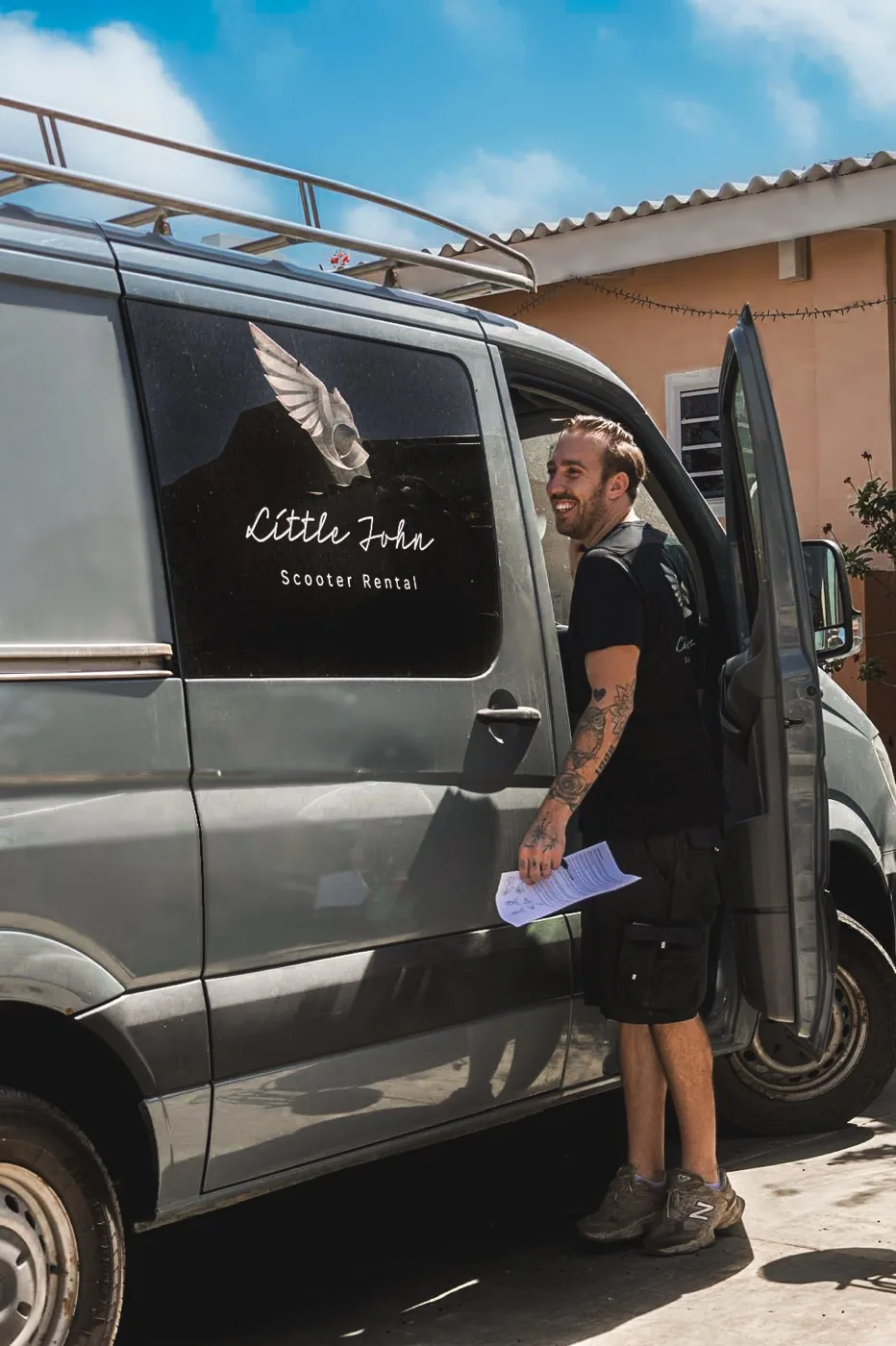 Sjonnie smiling at the door of the Little John delivery van